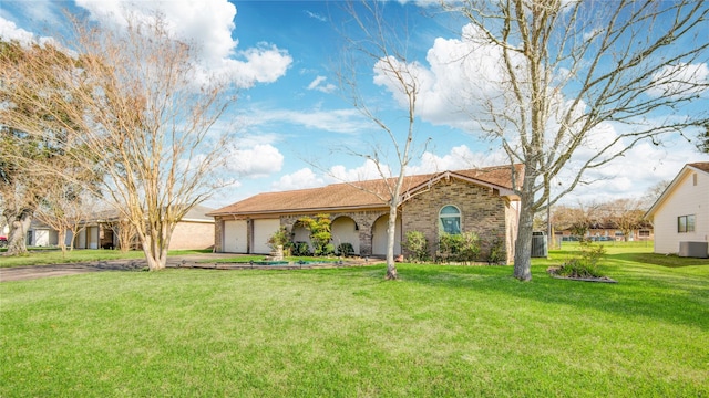 ranch-style house featuring brick siding, a front yard, a garage, cooling unit, and driveway