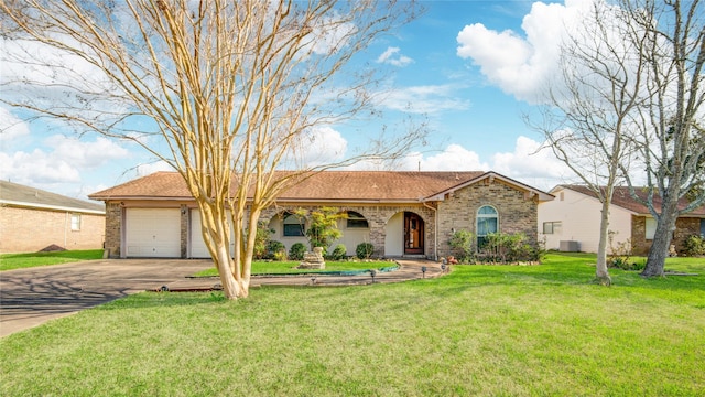 ranch-style house featuring brick siding, central AC unit, a garage, driveway, and a front lawn