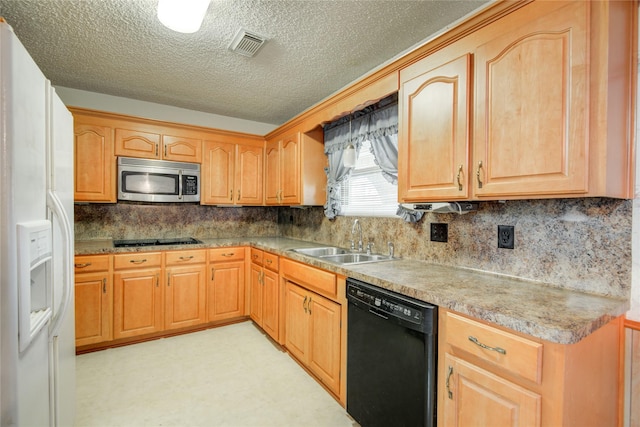 kitchen with light floors, visible vents, backsplash, a sink, and black appliances