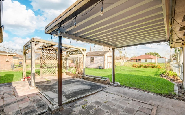 view of patio with an outbuilding and fence