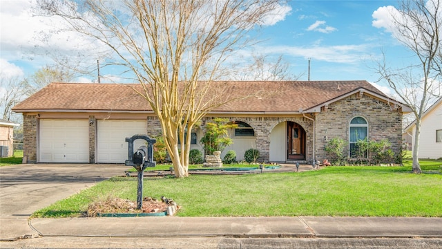 ranch-style home featuring a garage, a front yard, concrete driveway, and brick siding