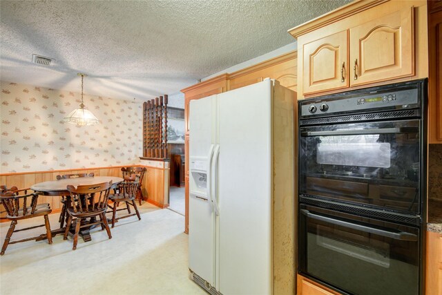 kitchen with wallpapered walls, white refrigerator with ice dispenser, dobule oven black, and a textured ceiling