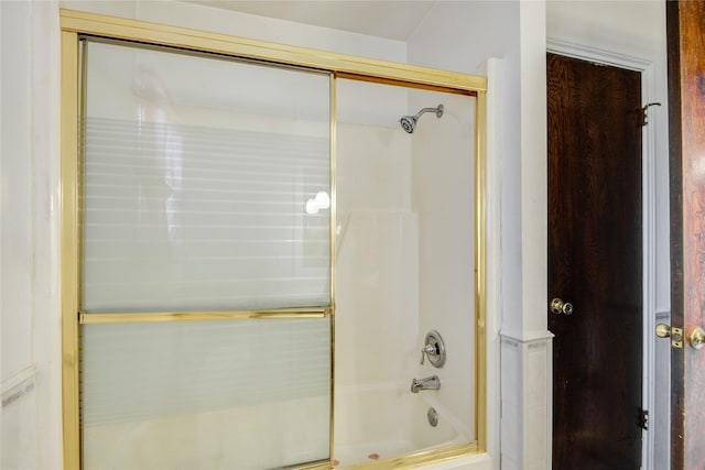 full bath featuring combined bath / shower with glass door