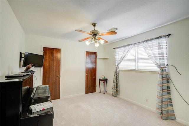 interior space with carpet floors, a ceiling fan, visible vents, and baseboards