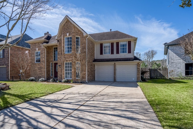 traditional-style house with driveway, a garage, a front lawn, and brick siding