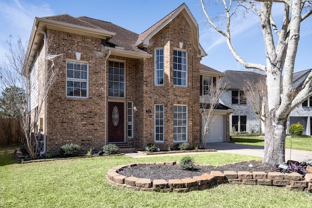 traditional-style house featuring driveway, a garage, a shingled roof, brick siding, and a front yard