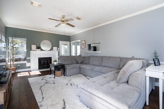 living room featuring crown molding, visible vents, and dark wood-type flooring