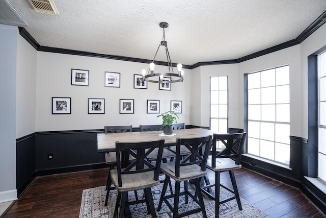 dining space featuring a wealth of natural light, visible vents, dark wood-type flooring, and ornamental molding