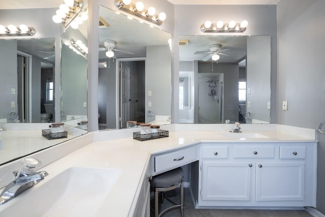 full bathroom featuring a sink, toilet, and a shower stall