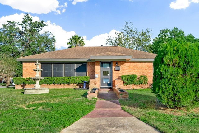 single story home with brick siding and a front lawn