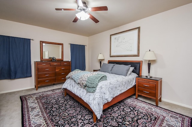 bedroom featuring baseboards, ceiling fan, and light colored carpet