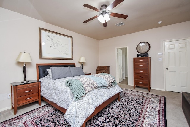 bedroom with light carpet, a ceiling fan, visible vents, and baseboards