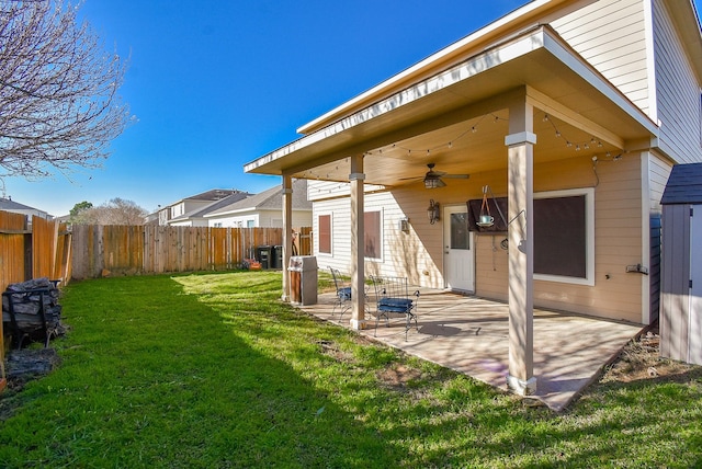 view of yard with a patio area, a fenced backyard, and a ceiling fan