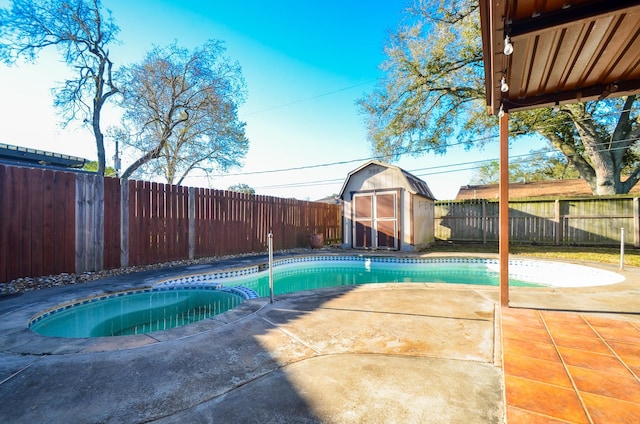 view of swimming pool featuring a patio, a fenced backyard, a shed, a fenced in pool, and an in ground hot tub