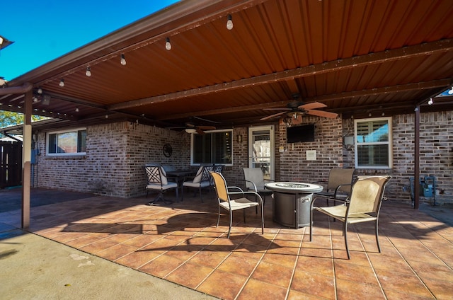 view of patio / terrace featuring a fire pit and ceiling fan