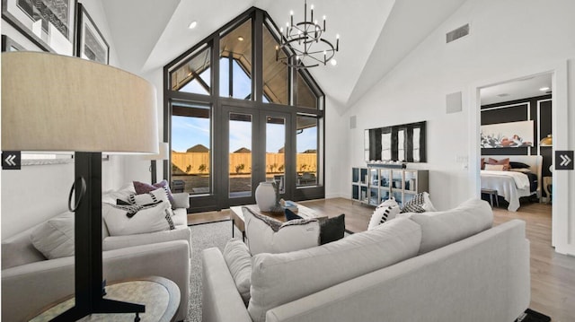 409 Silver Moon Way, Katy, TX 77493 - living room with a chandelier, high vaulted ceiling, wood finished floors, french doors, and recessed lighting