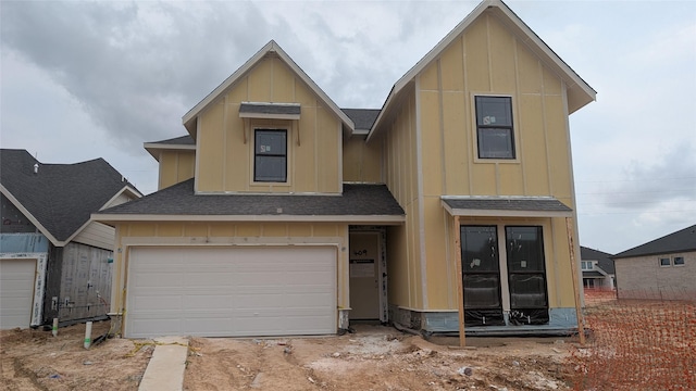 409 Silver Moon Way, Katy, TX 77493 - view of front of house with a shingled roof, board and batten siding, and a garage