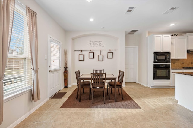 dining area with light tile patterned floors, visible vents, and recessed lighting