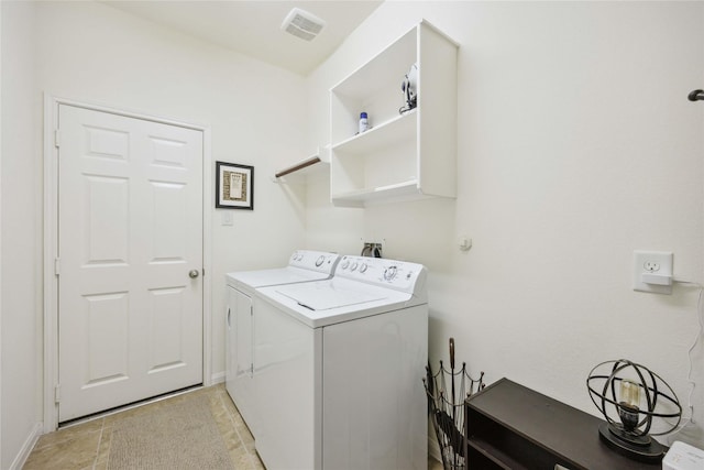 washroom featuring washer and dryer, laundry area, and visible vents