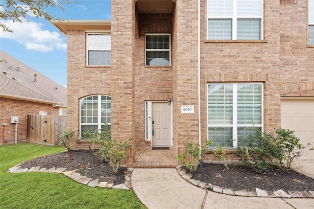 view of front of house with brick siding and fence