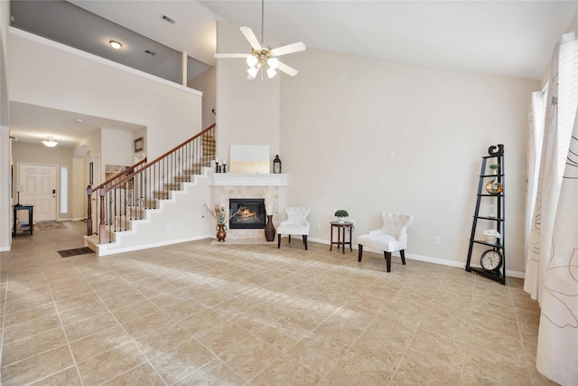 unfurnished room featuring arched walkways, a fireplace, stairway, high vaulted ceiling, and baseboards