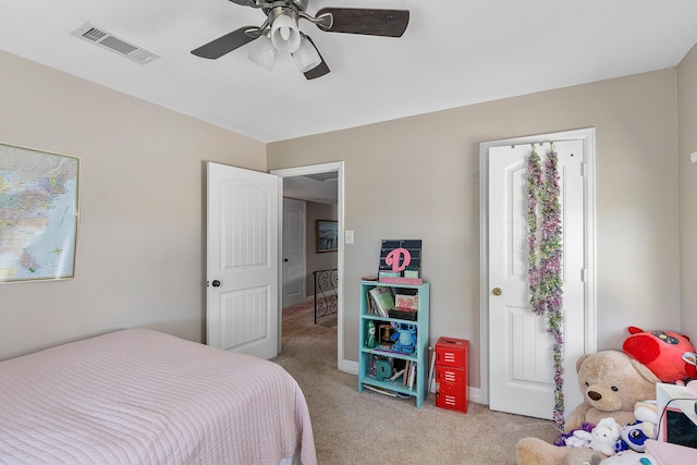 bedroom featuring ceiling fan, visible vents, and light carpet