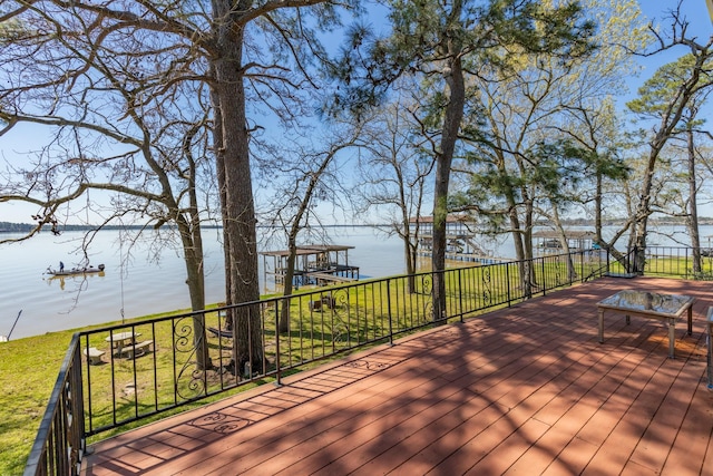 wooden terrace with a dock and a water view