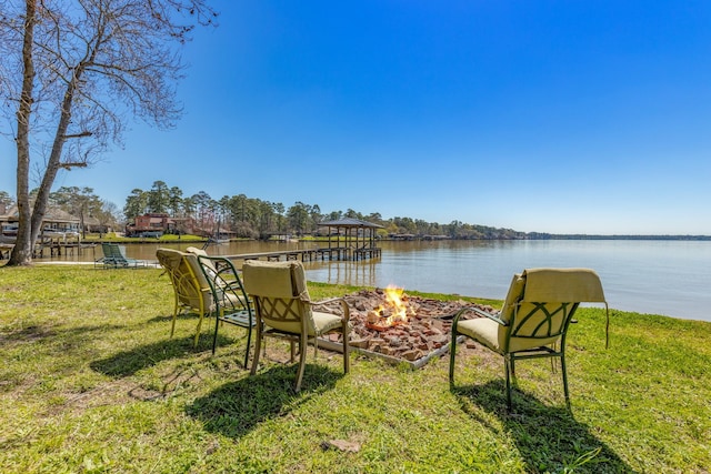 view of yard featuring a fire pit and a water view