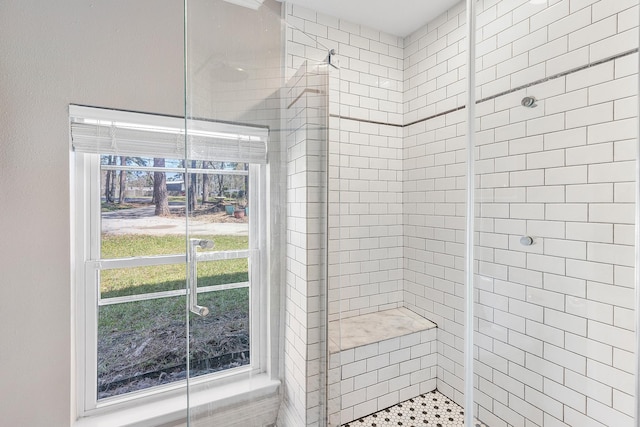 bathroom with tiled shower