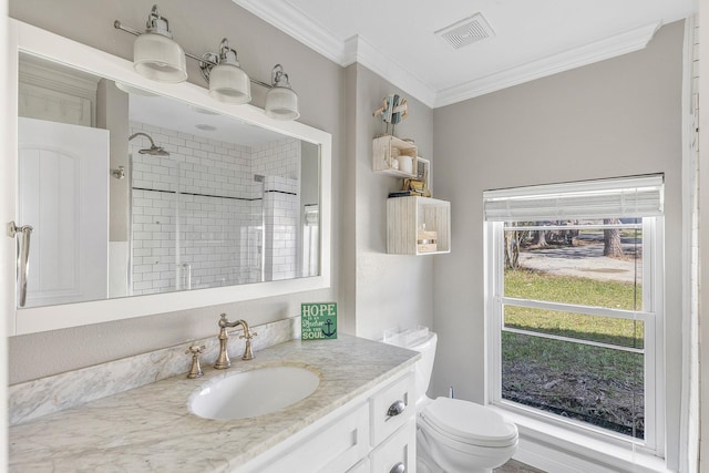 bathroom featuring visible vents, crown molding, toilet, a tile shower, and vanity