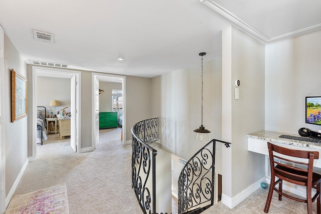 corridor featuring light colored carpet, an upstairs landing, visible vents, and baseboards