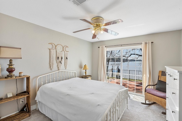 bedroom with visible vents, light colored carpet, access to exterior, and a ceiling fan