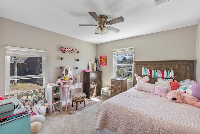 bedroom featuring a ceiling fan, visible vents, and carpet floors