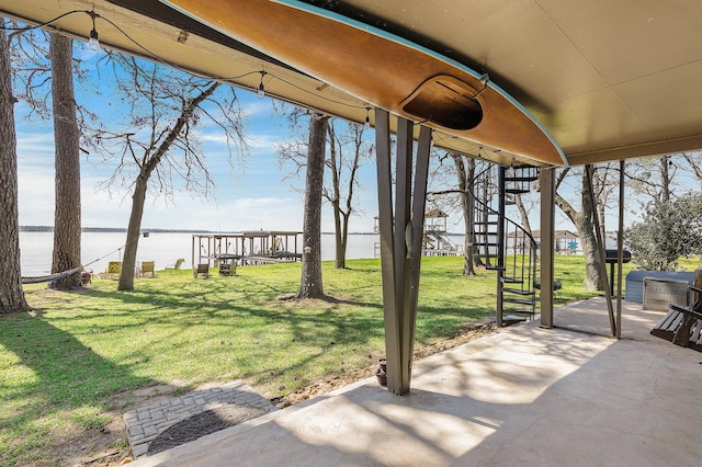 exterior space featuring a patio, stairway, and a water view