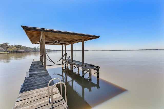 dock area with a water view and boat lift