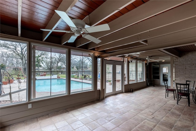 unfurnished sunroom with ceiling fan, french doors, beamed ceiling, and wood ceiling