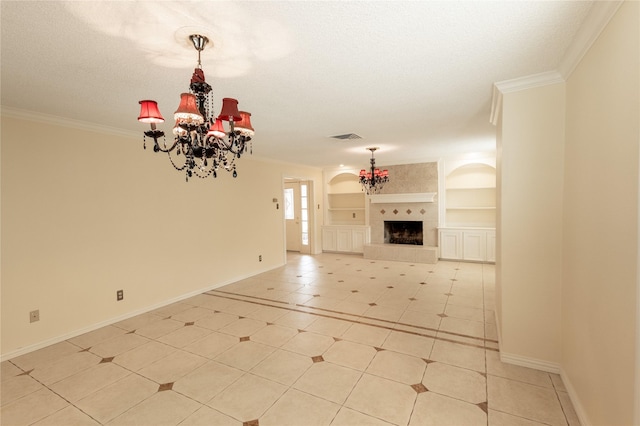 unfurnished living room featuring built in shelves, visible vents, ornamental molding, a tiled fireplace, and an inviting chandelier