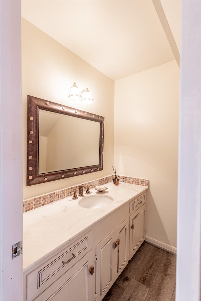 bathroom featuring wood finished floors, vanity, and baseboards