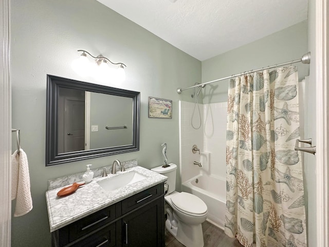 bathroom featuring shower / bath combo, toilet, wood finished floors, a textured ceiling, and vanity