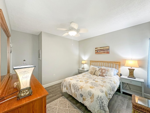 bedroom with wood finished floors, a ceiling fan, and baseboards