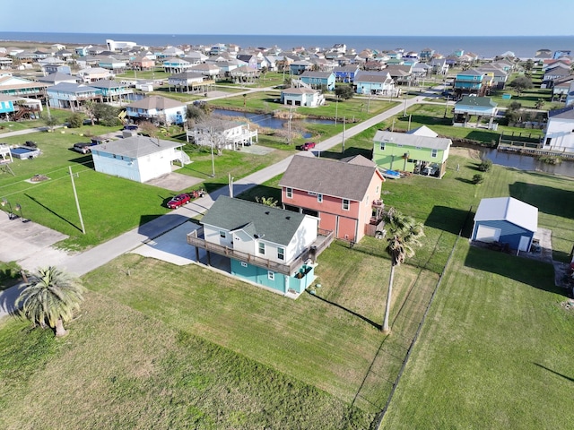 drone / aerial view with a residential view and a water view