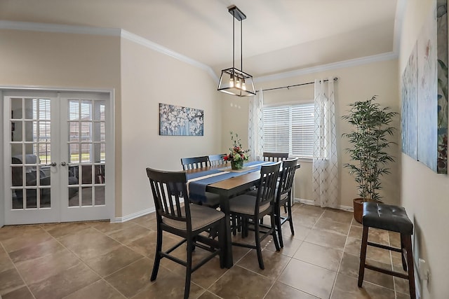 tiled dining room featuring a wealth of natural light, crown molding, and french doors