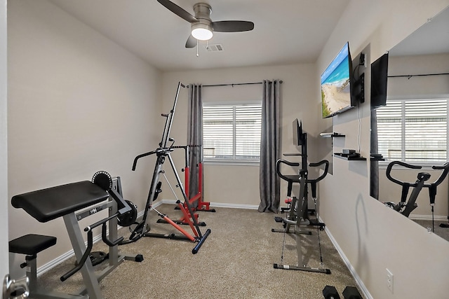 exercise area featuring carpet flooring, ceiling fan, visible vents, and baseboards