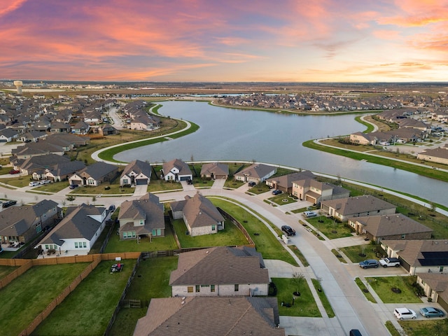 drone / aerial view with a residential view and a water view