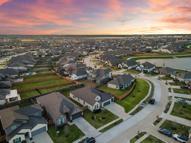 bird's eye view with a water view and a residential view