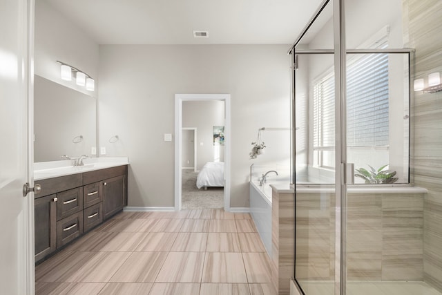 bathroom featuring visible vents, ensuite bathroom, vanity, a shower stall, and baseboards