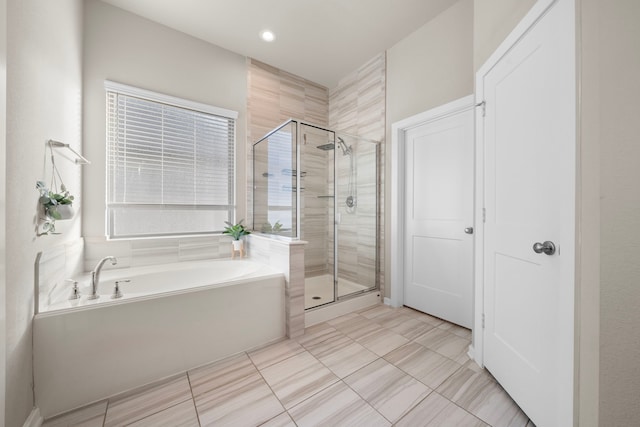 full bath featuring a shower stall and a bath