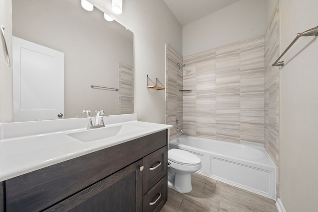 full bath featuring wood tiled floor, tub / shower combination, vanity, and toilet