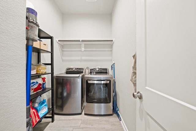 washroom featuring laundry area and washing machine and clothes dryer