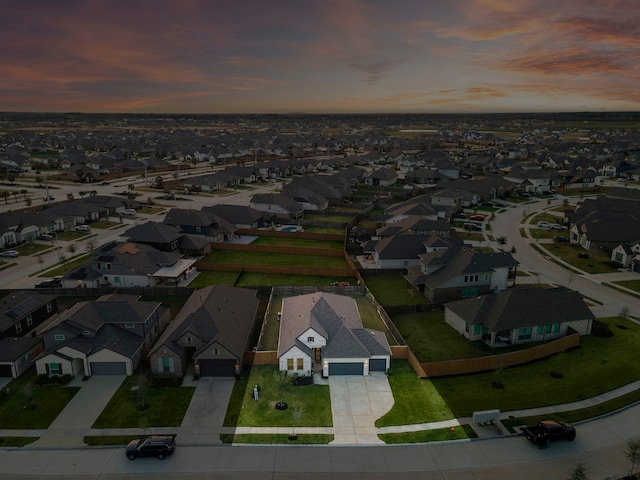 aerial view at dusk featuring a residential view